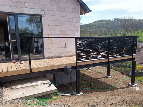 Detailní pohled na moderní terasu s dřevoplastovou podlahou a designovým zábradlím
